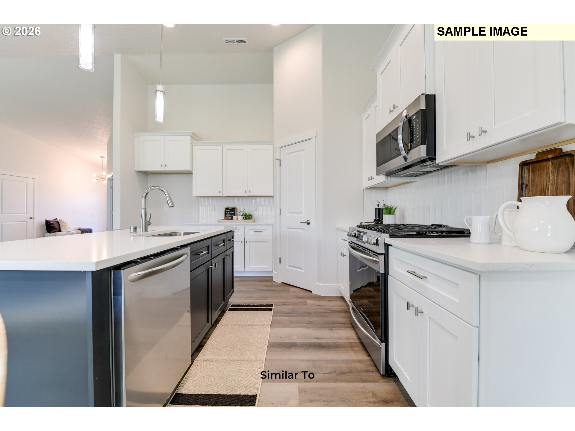 215 Southwest Sparrow Street Boardman, OR 97818 - Photo 7 of 28 a kitchen with stainless steel appliances a sink stove and cabinets