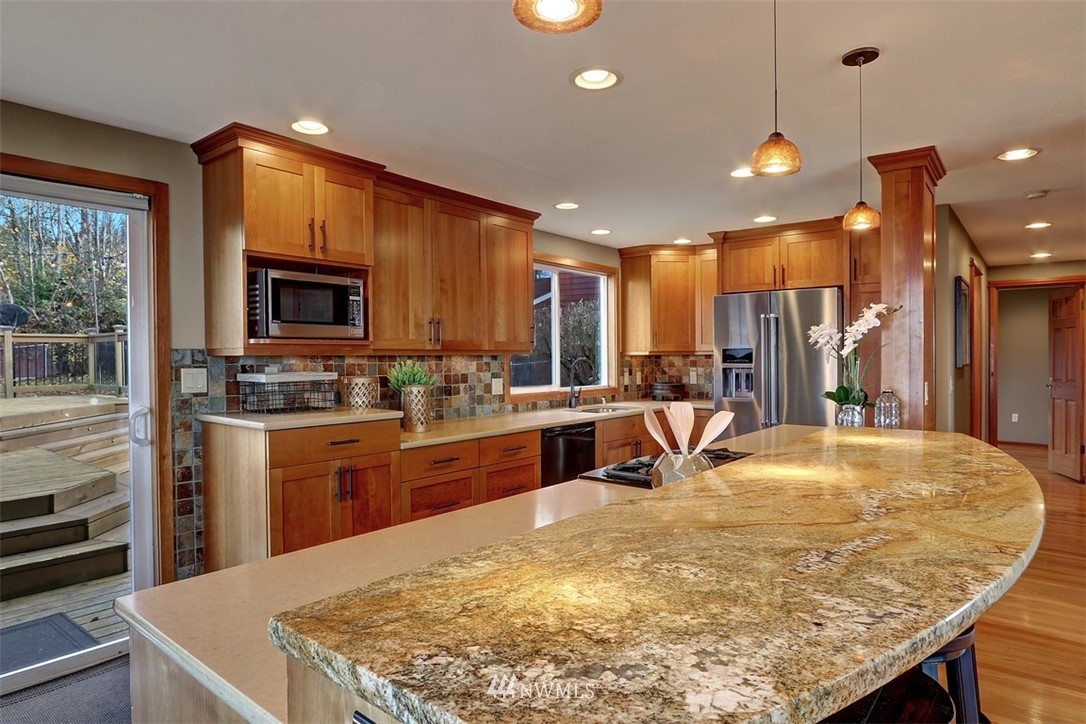 17041 Talbot Road Edmonds, WA 98026 - Photo 2 of 25 a kitchen with stainless steel appliances granite countertop a sink a stove and a refrigerator