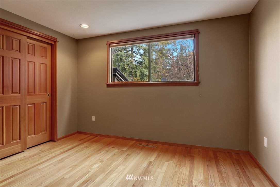 17041 Talbot Road Edmonds, WA 98026 - Photo 14 of 25 an empty room with wooden floor and windows