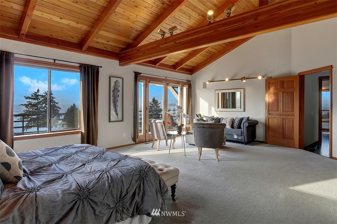 17041 Talbot Road Edmonds, WA 98026 - Photo 4 of 25 a spacious bedroom with a bed and glass door