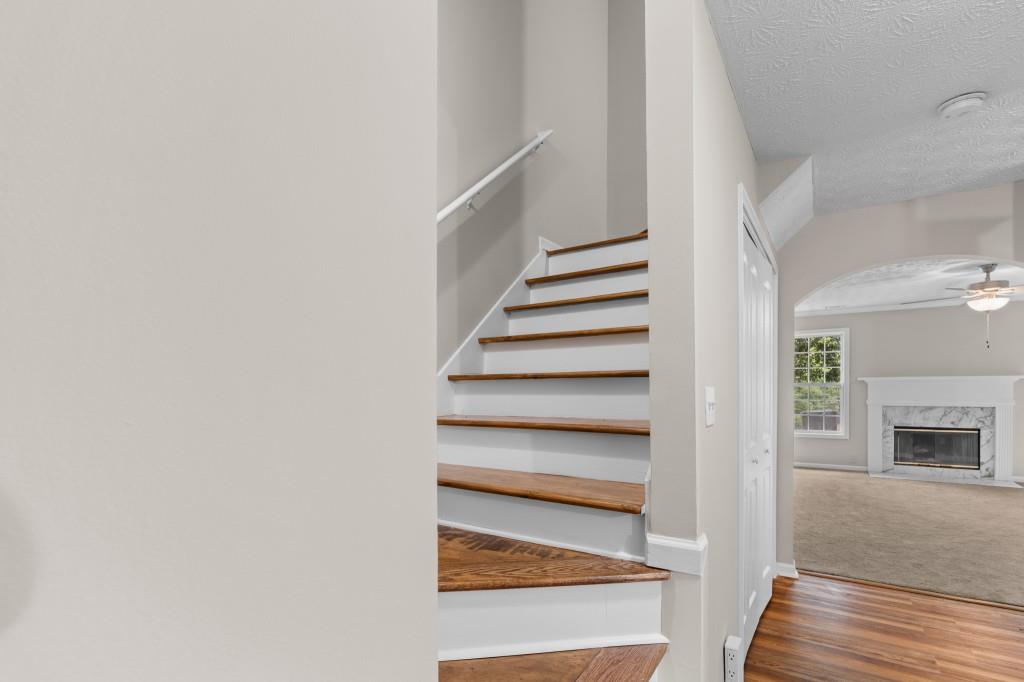 3525 Magnolia Walk Trail Cumming, GA 30040 - Photo 12 of 31 a view of entryway with wooden floor and a fireplace