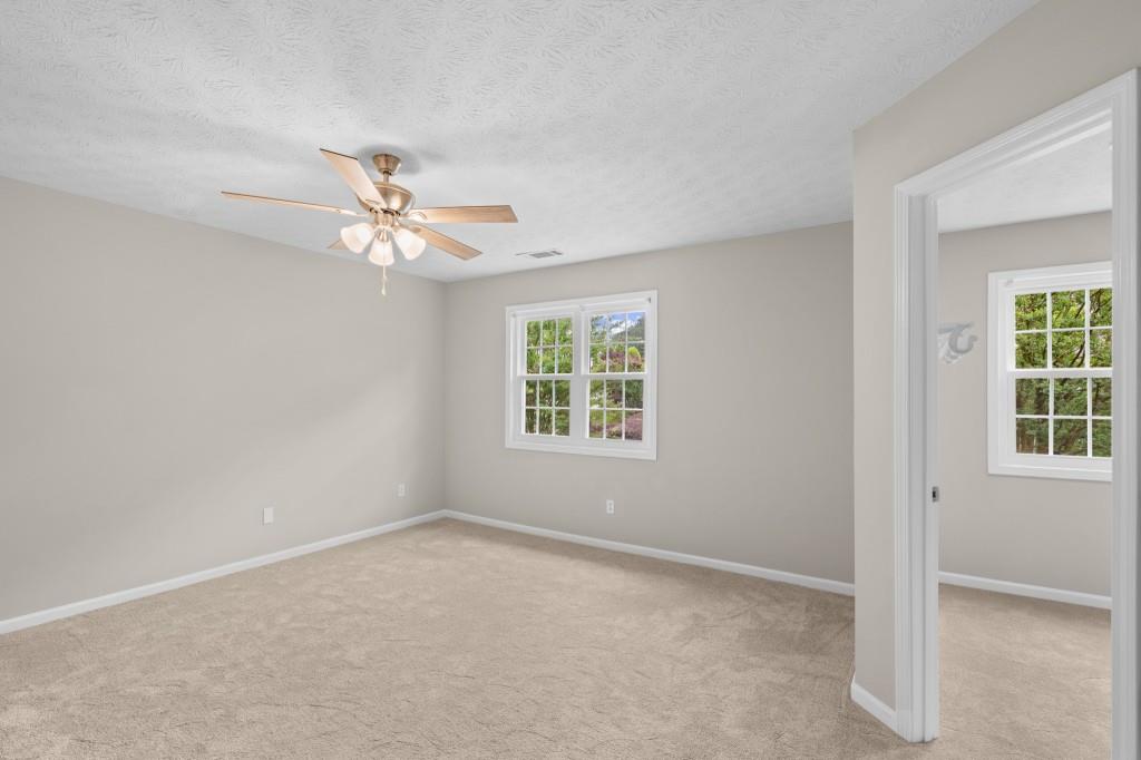3525 Magnolia Walk Trail Cumming, GA 30040 - Photo 13 of 31 an empty room with windows and fan