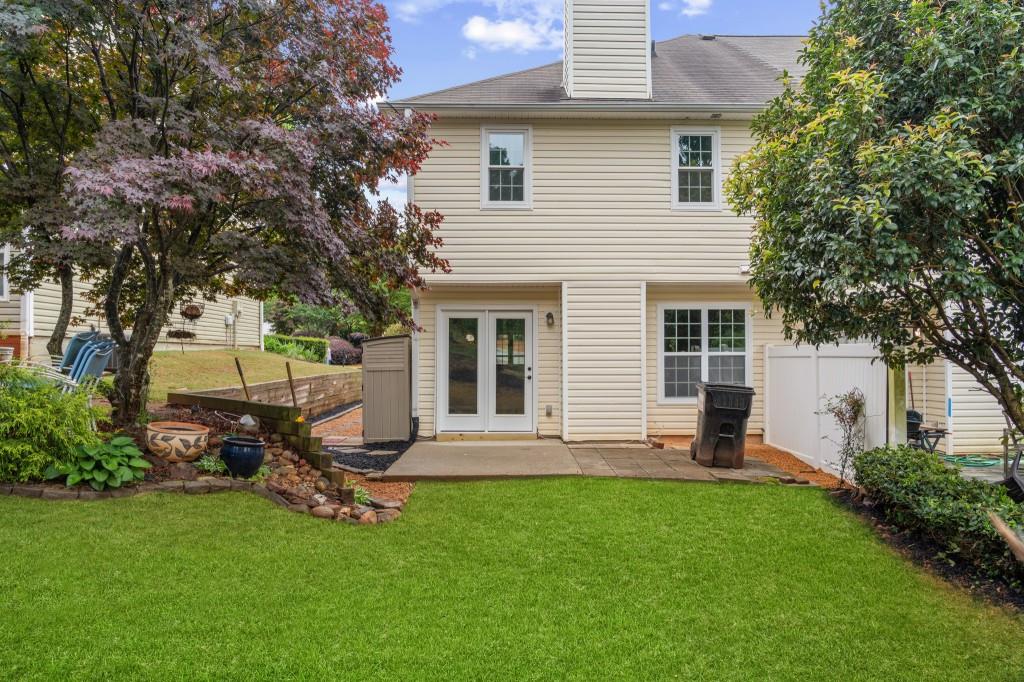 3525 Magnolia Walk Trail Cumming, GA 30040 - Photo 22 of 31 a view of a backyard with table and chairs and a tree