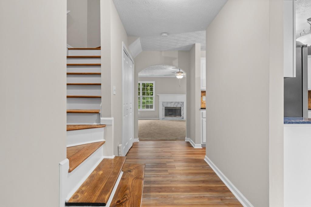 3525 Magnolia Walk Trail Cumming, GA 30040 - Photo 3 of 31 a view of a hallway with wooden floor and staircase