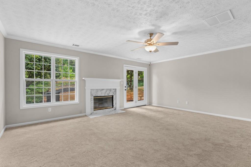 3525 Magnolia Walk Trail Cumming, GA 30040 - Photo 8 of 31 an empty room with chandelier fan and windows
