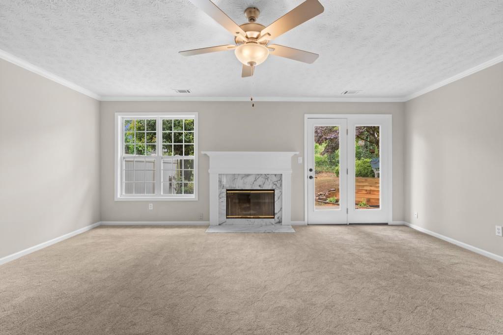 3525 Magnolia Walk Trail Cumming, GA 30040 - Photo 10 of 31 an empty room with windows and a fireplace
