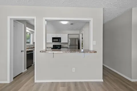 a view of living room with furniture and wooden floor
