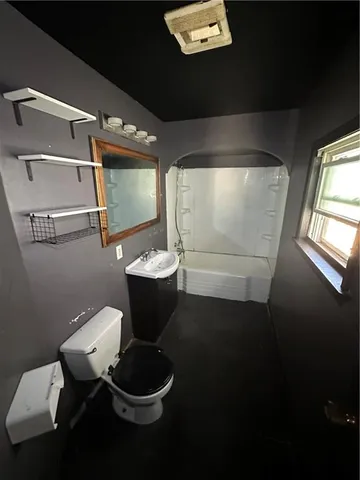 a view of hallway with window and stairs