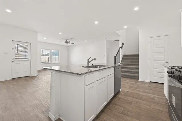 a kitchen with sink and cabinets