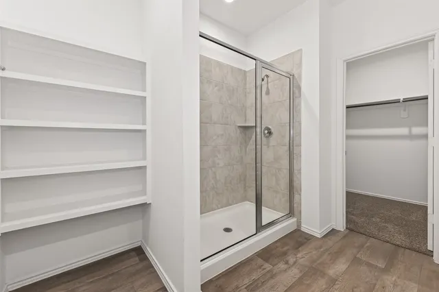 a bathroom with a glass shower door