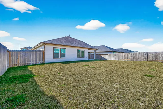 a view of a house with a backyard
