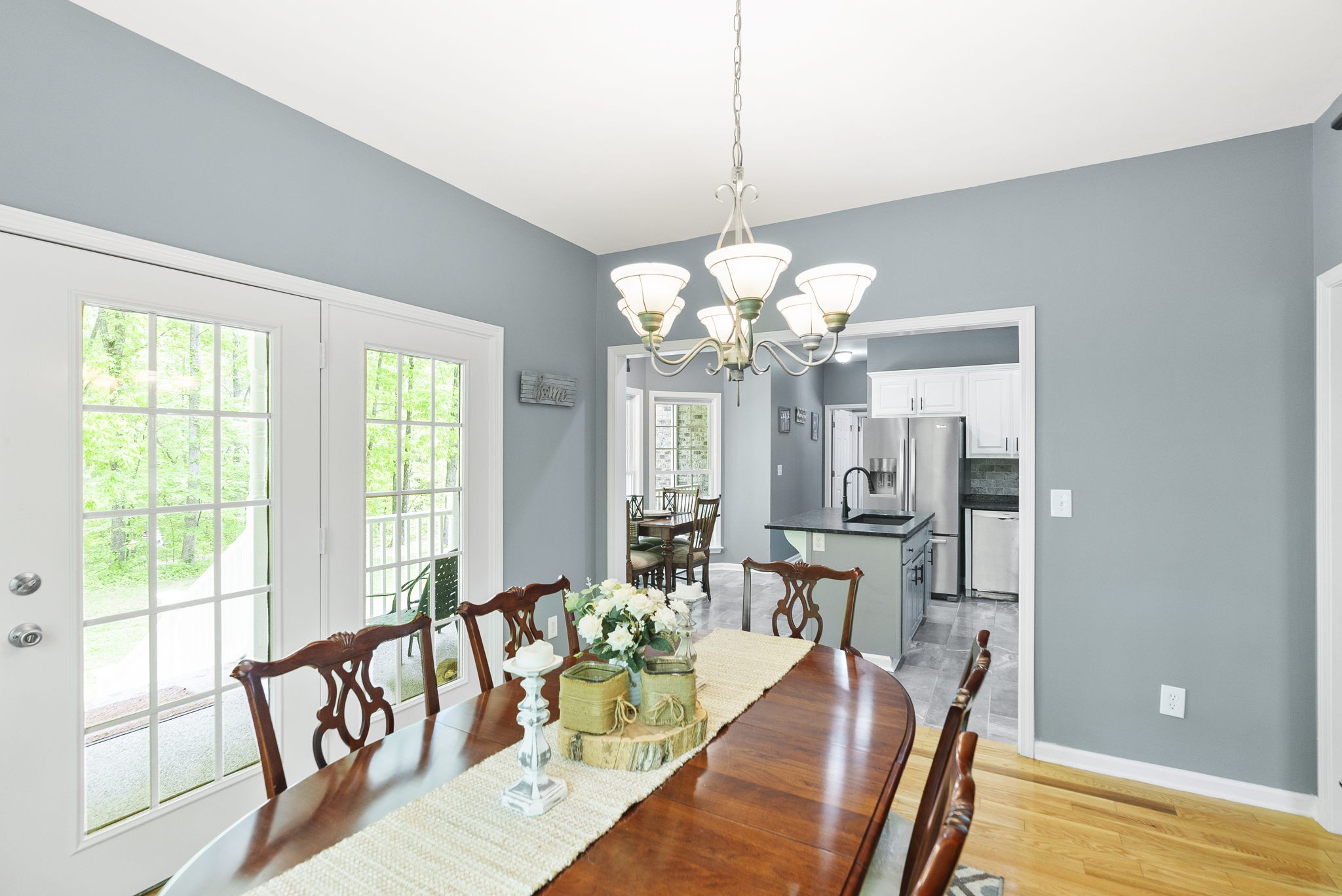 5298 Ridge Road Joelton, TN 37080 - Photo 17 of 46 a view of a dining room with furniture a chandelier and wooden floor