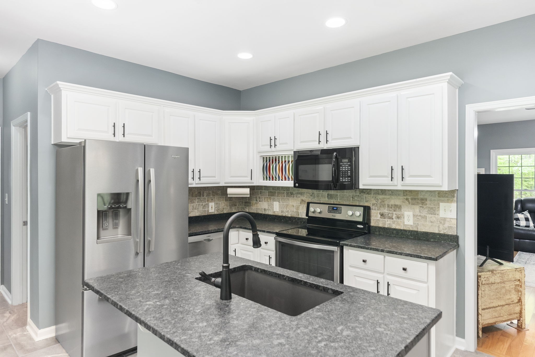 5298 Ridge Road Joelton, TN 37080 - Photo 20 of 46 a kitchen with stainless steel appliances granite countertop a sink stove microwave and refrigerator