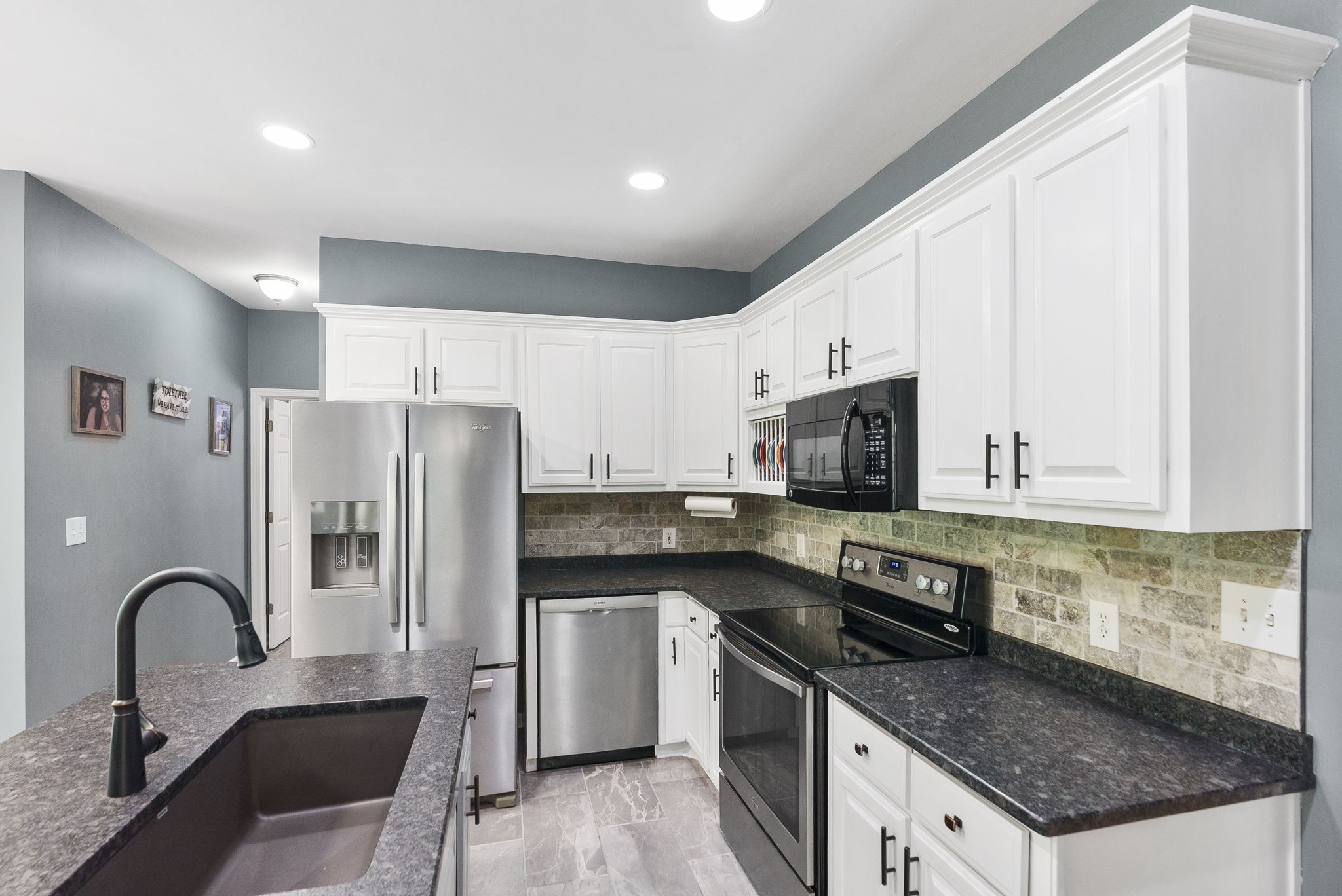 5298 Ridge Road Joelton, TN 37080 - Photo 21 of 46 a kitchen with stainless steel appliances granite countertop a refrigerator a sink a stove a microwave and cabinets