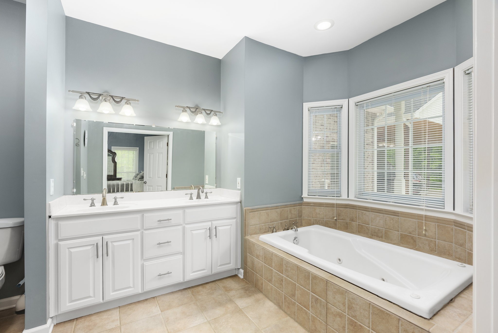 5298 Ridge Road Joelton, TN 37080 - Photo 33 of 46 a bathroom with a tub a sink and mirror