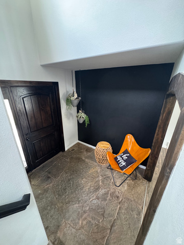 1237 South 260 West Payson, UT 84651 - Photo 29 of 81 Dark wood-finish entry door with paneling, flagstone-style flooring, and a dark accent wall