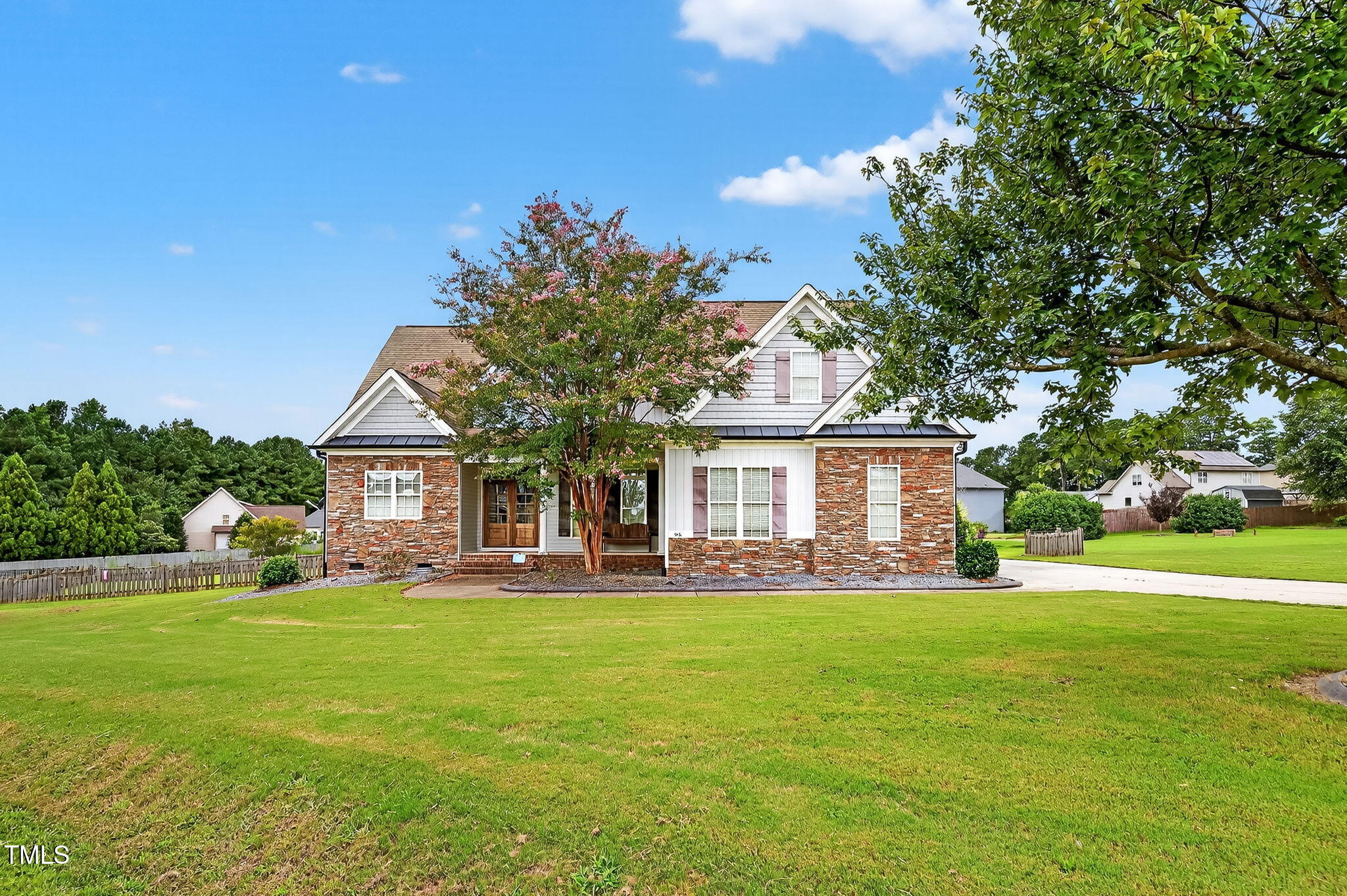 a front view of house with yard and green space