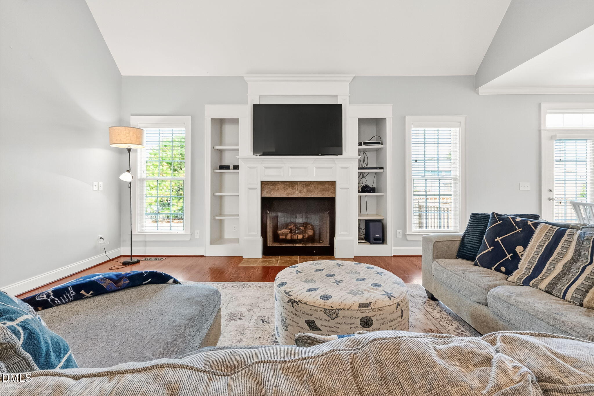 96 Jackson Ridge Court Willow Spring, NC 27592 - Photo 10 of 54 a living room with a couch a flat screen tv and a fireplace