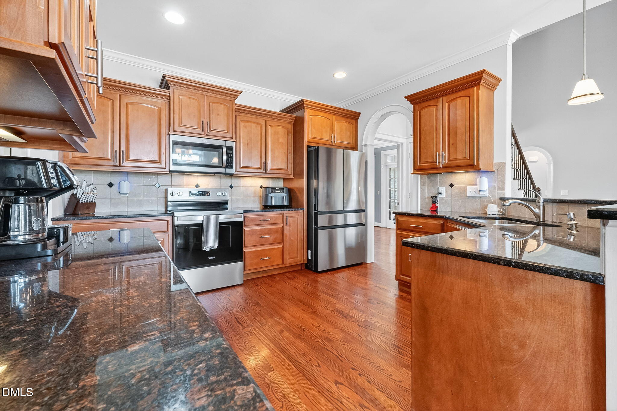 96 Jackson Ridge Court Willow Spring, NC 27592 - Photo 13 of 54 a kitchen with stainless steel appliances granite countertop a refrigerator a stove and a sink with wooden floors