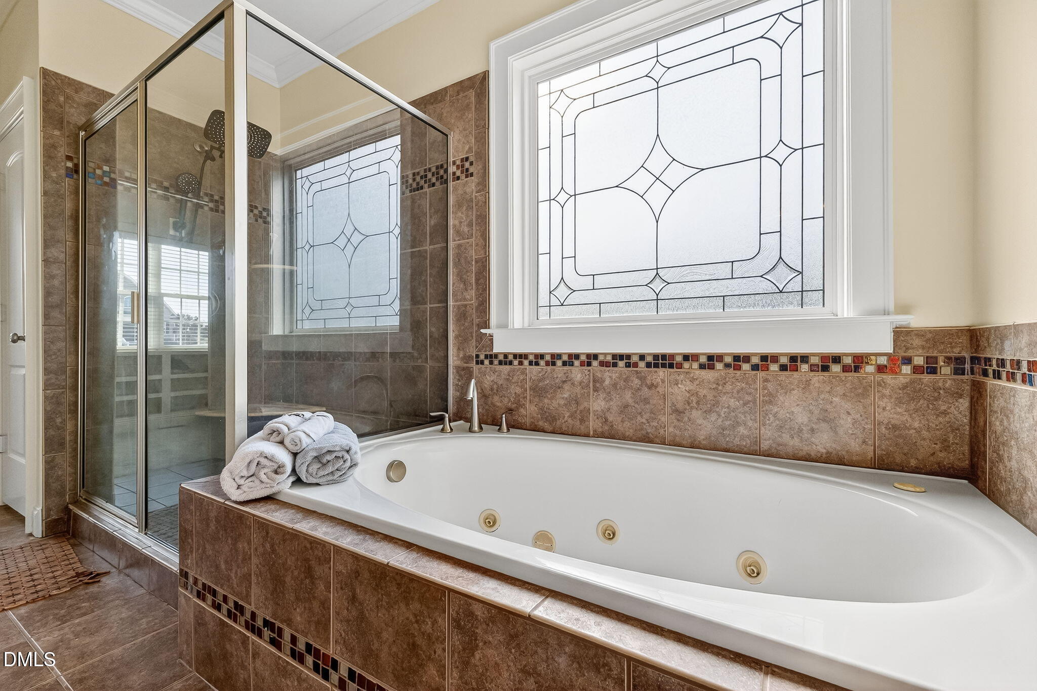 96 Jackson Ridge Court Willow Spring, NC 27592 - Photo 27 of 54 a bathroom with a tub a window and a shower