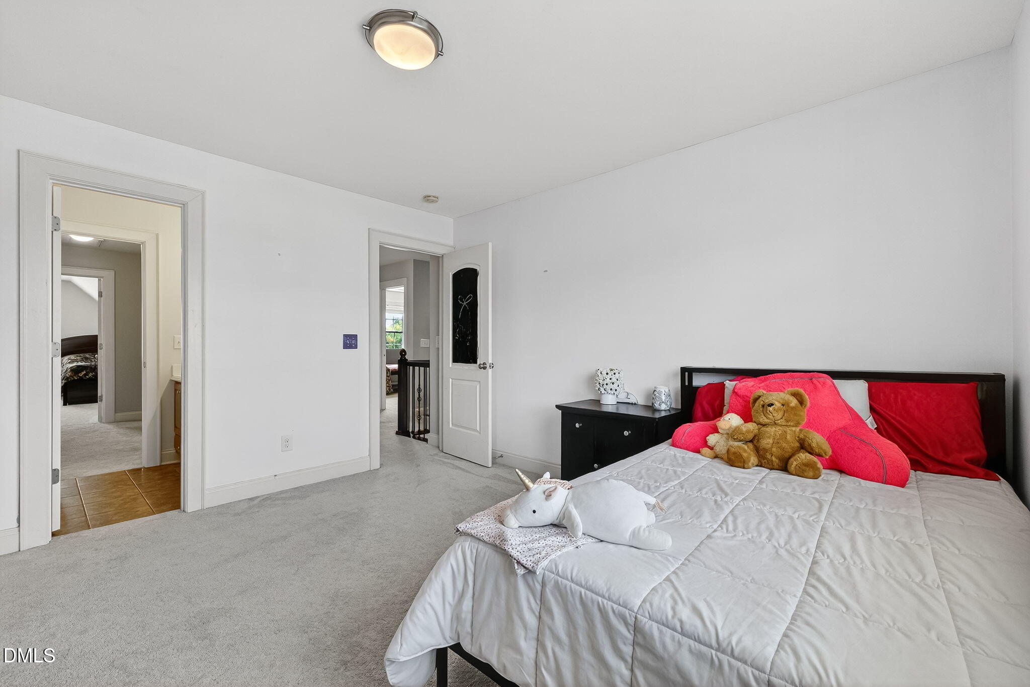 96 Jackson Ridge Court Willow Spring, NC 27592 - Photo 42 of 54 a bedroom with a large bed and a chandelier