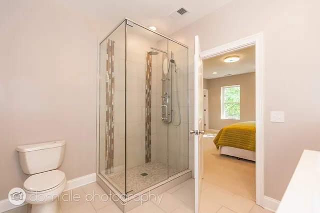 a bathroom with a toilet and a shower