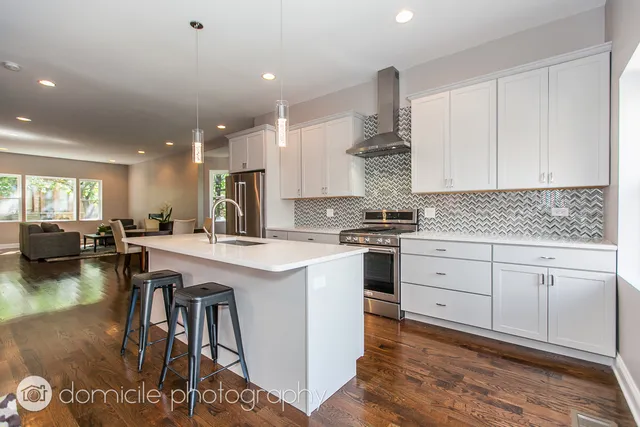a kitchen with a table chairs stove and cabinets