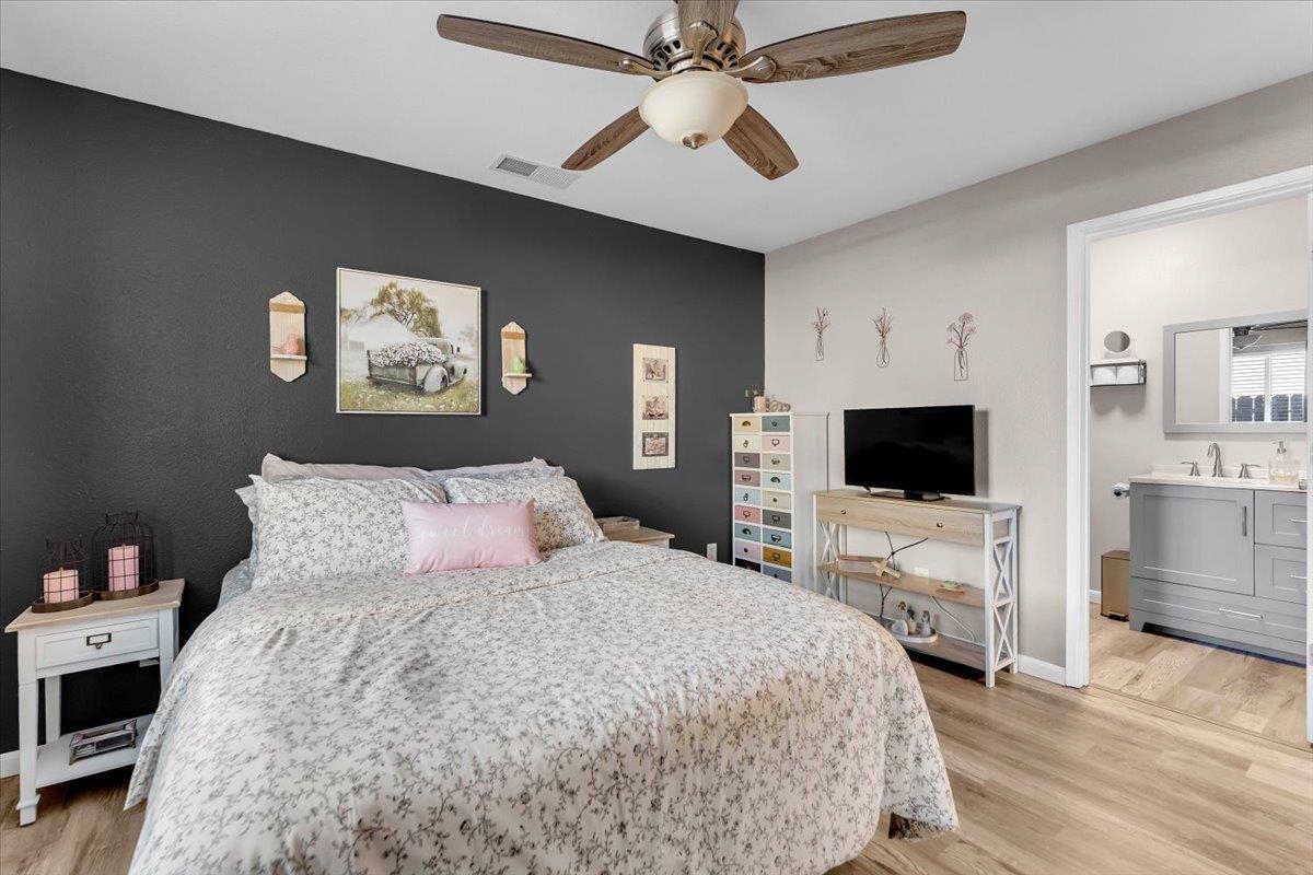 2110 Gentry Way Red Bluff, CA 96080 - Photo 17 of 47 a bedroom with a bed and a flat screen tv