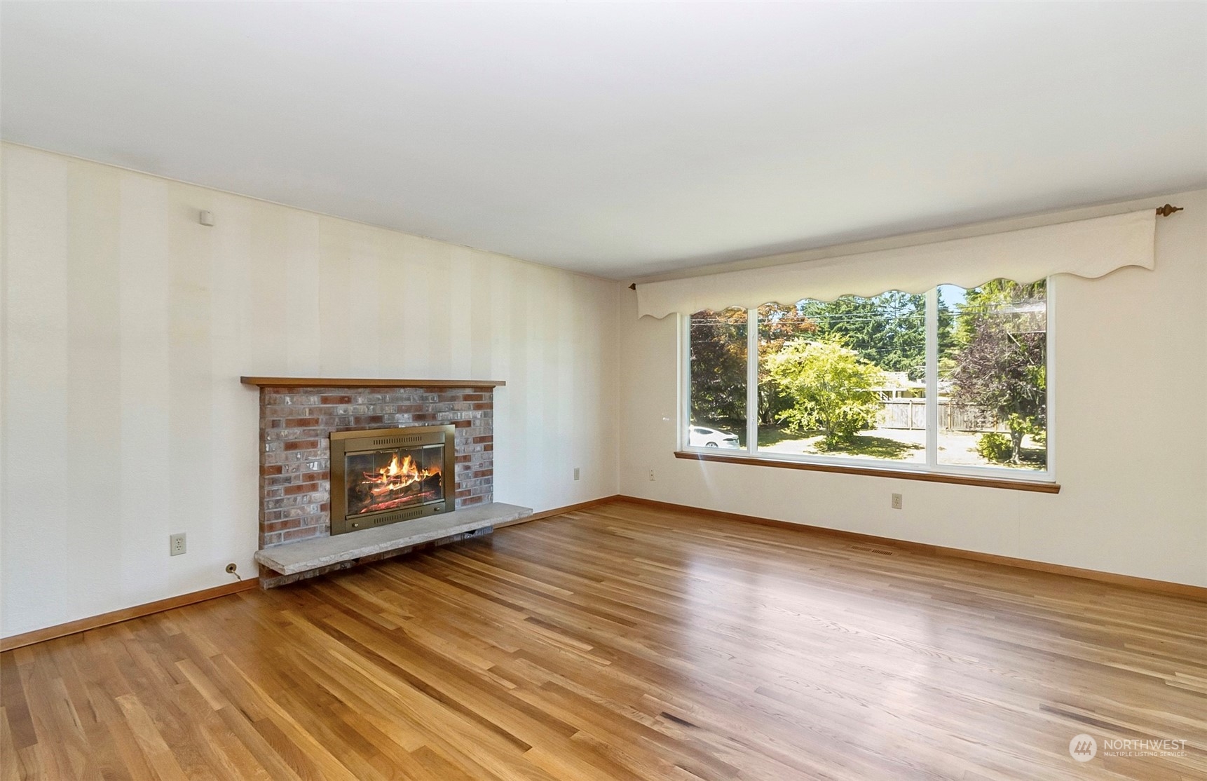2520 166th Avenue Northeast Bellevue, WA 98008 - Photo 14 of 40 an empty room with wooden floor fire place and windows