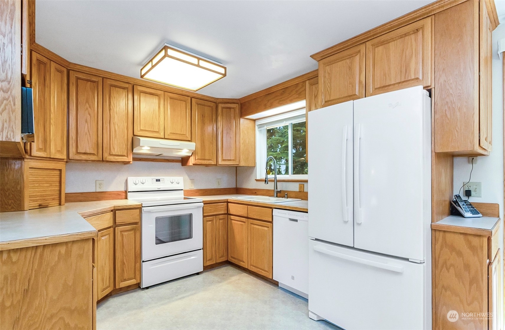 2520 166th Avenue Northeast Bellevue, WA 98008 - Photo 16 of 40 a kitchen with a sink a refrigerator and window