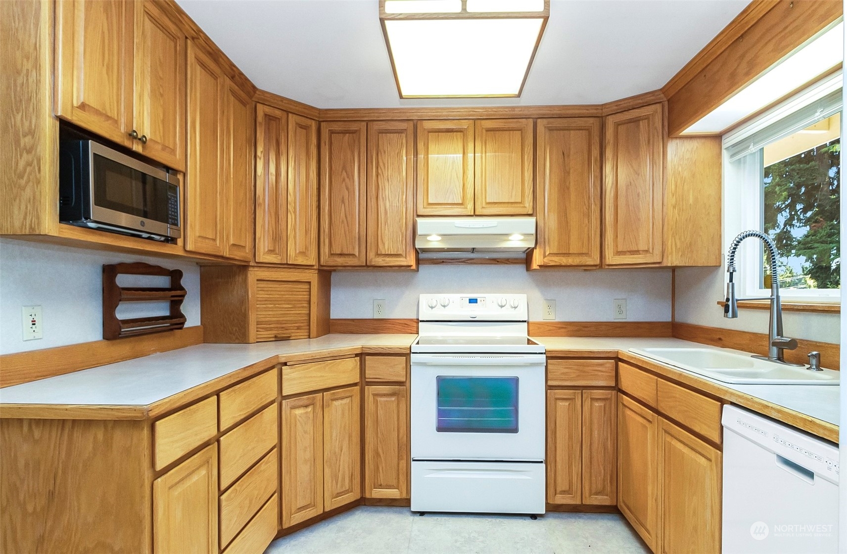 2520 166th Avenue Northeast Bellevue, WA 98008 - Photo 17 of 40 a kitchen with stainless steel appliances granite countertop a sink a stove and cabinets