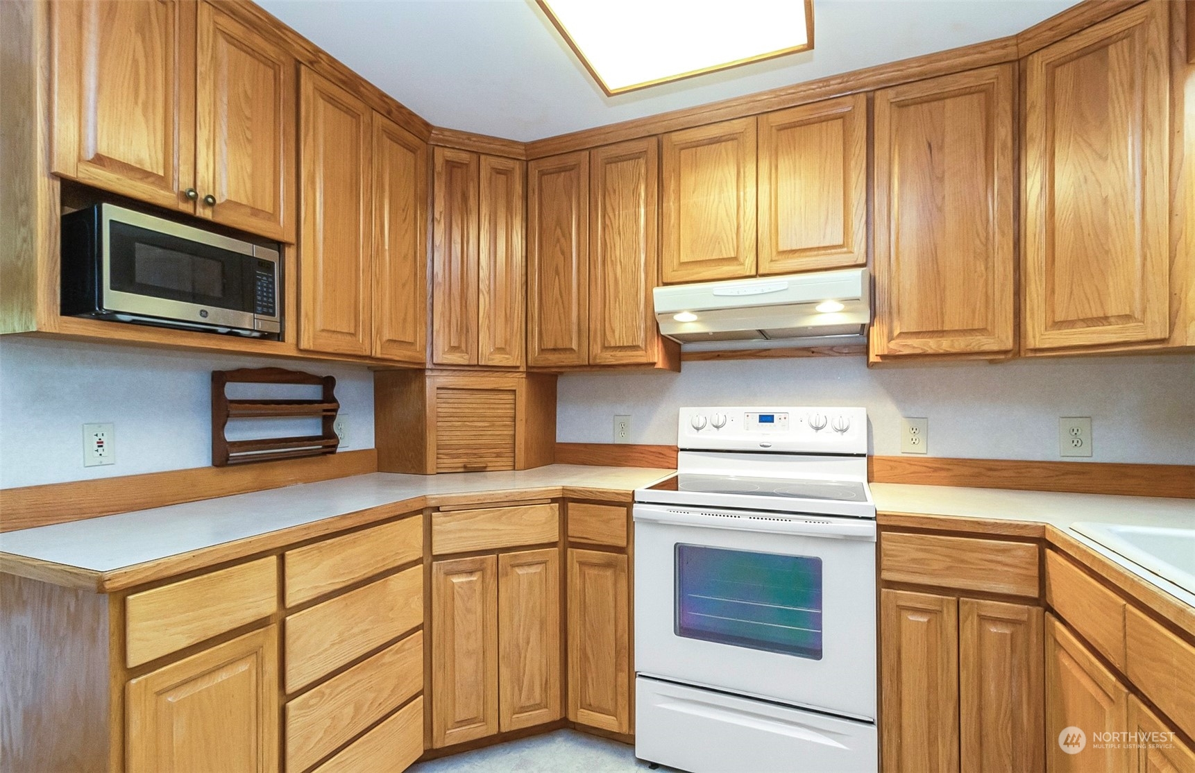 2520 166th Avenue Northeast Bellevue, WA 98008 - Photo 18 of 40 a kitchen with stainless steel appliances granite countertop cabinets and a microwave oven