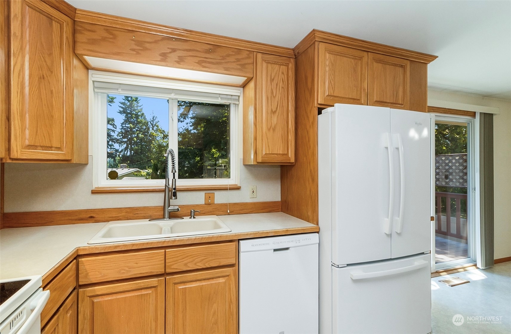 2520 166th Avenue Northeast Bellevue, WA 98008 - Photo 19 of 40 a kitchen with a refrigerator and a sink