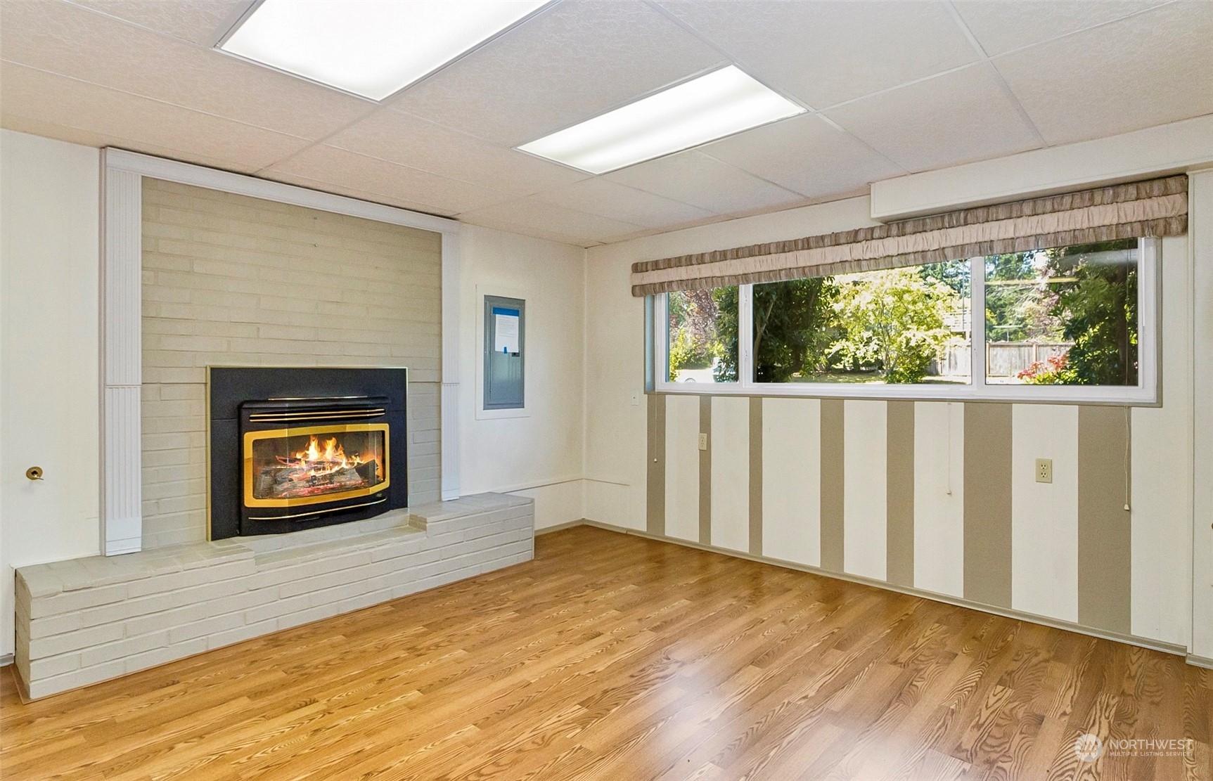 2520 166th Avenue Northeast Bellevue, WA 98008 - Photo 40 of 40 a view of an empty room with wooden floor fireplace and a window