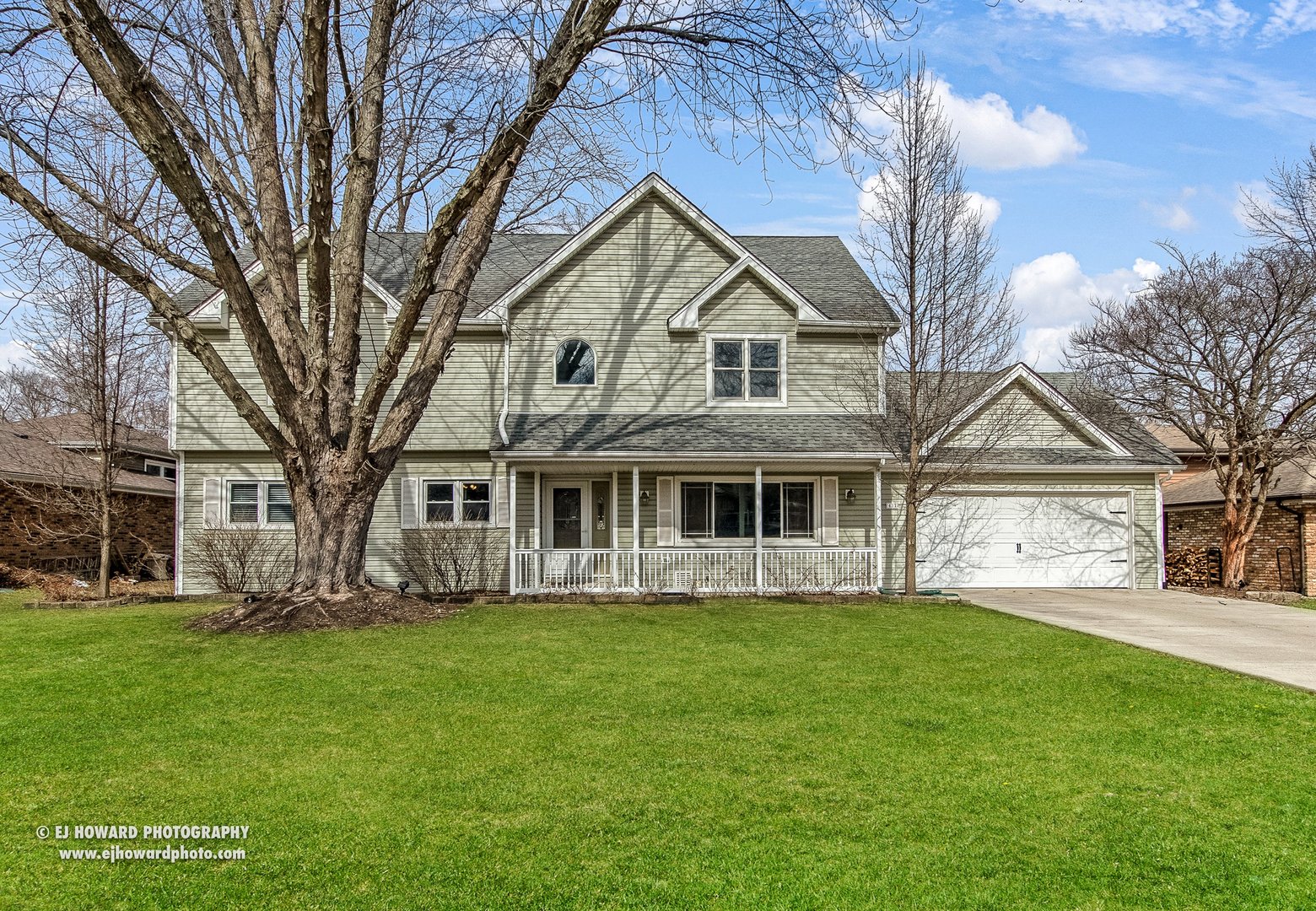 a front view of house with yard and green space