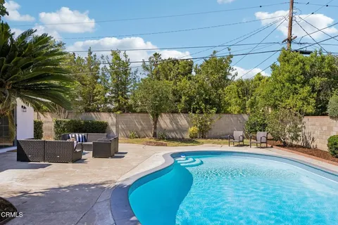 a backyard of a house with table and chairs