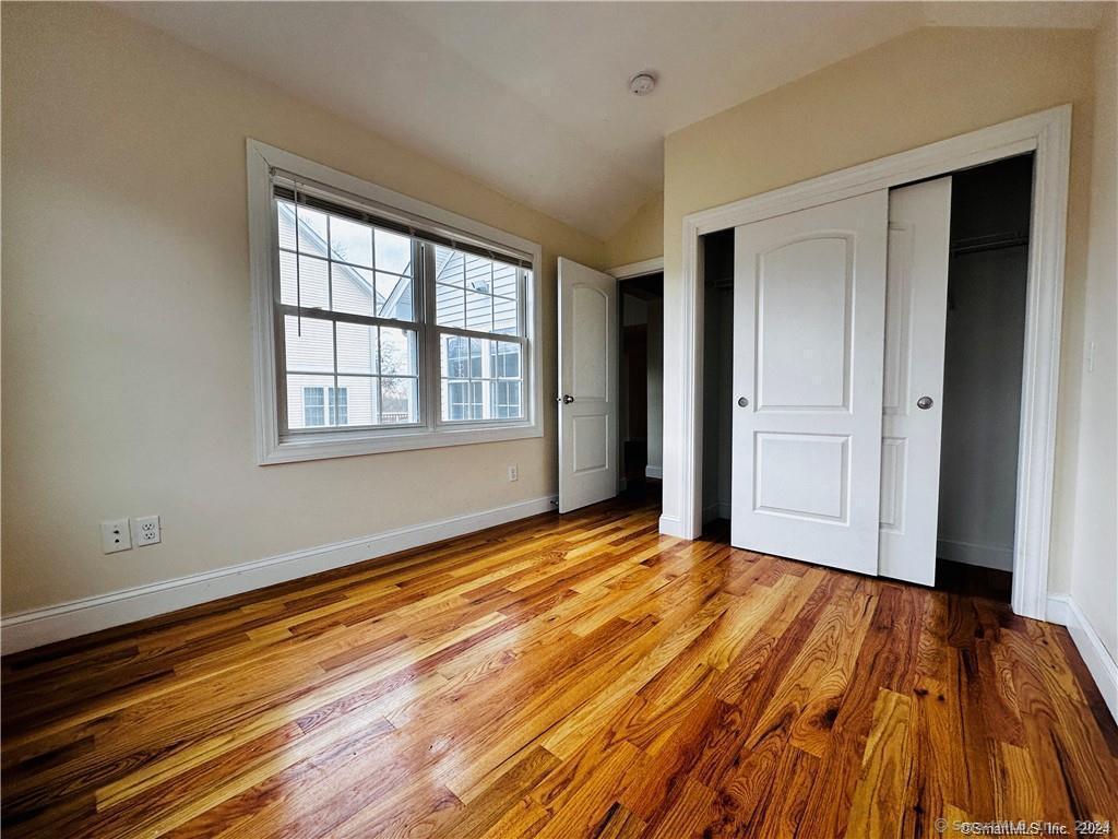 31 Brainerd Road Branford, CT 06405 - Photo 27 of 39 a view of an empty room with wooden floor and a window