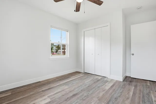 a view of room with window and wooden floor
