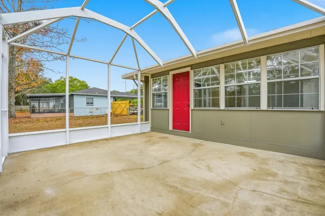 a house view with swimming pool in front of it