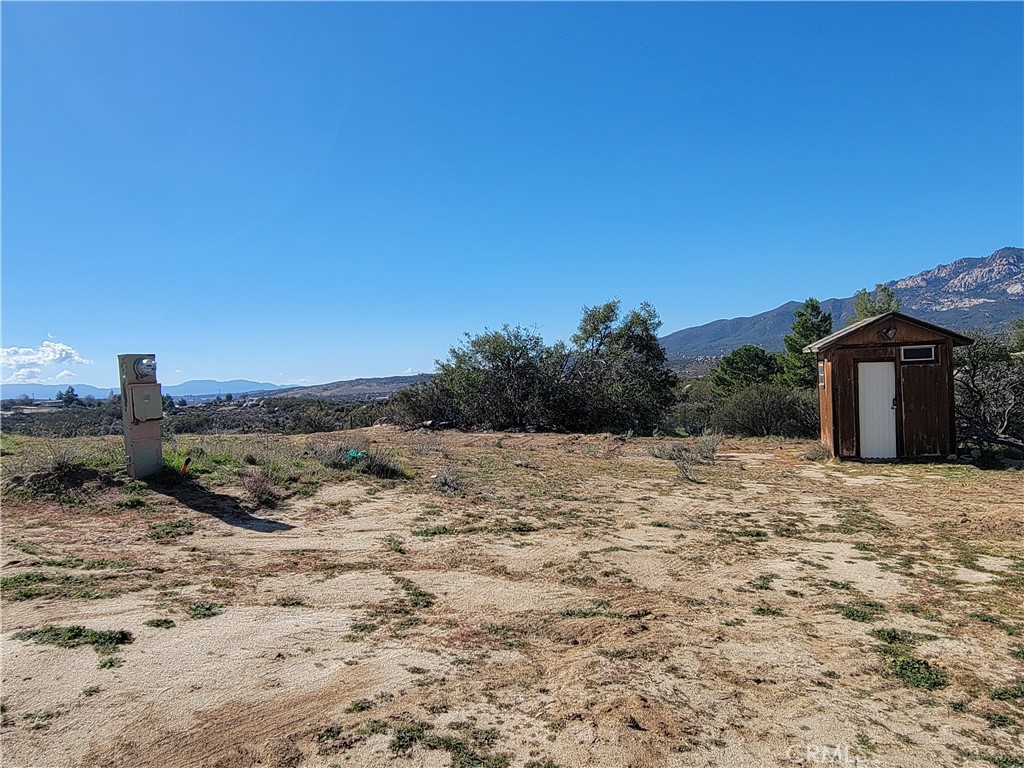 53595 Cave Rock Road Anza, CA 92539 - Photo 2 of 14 a view of a dry yard with wooden fence