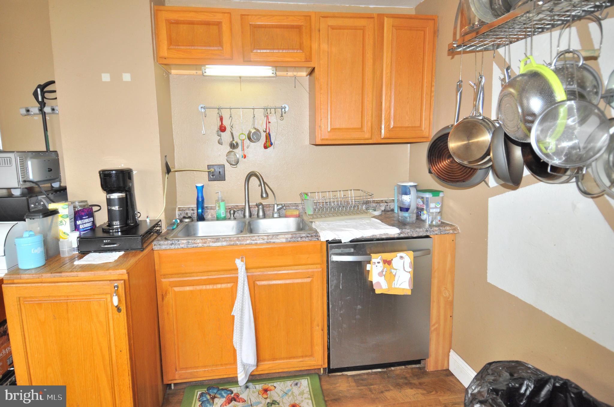 105 Front Street Pocomoke City, MD 21851 - Photo 12 of 50 a kitchen with a sink a stove and a dining table