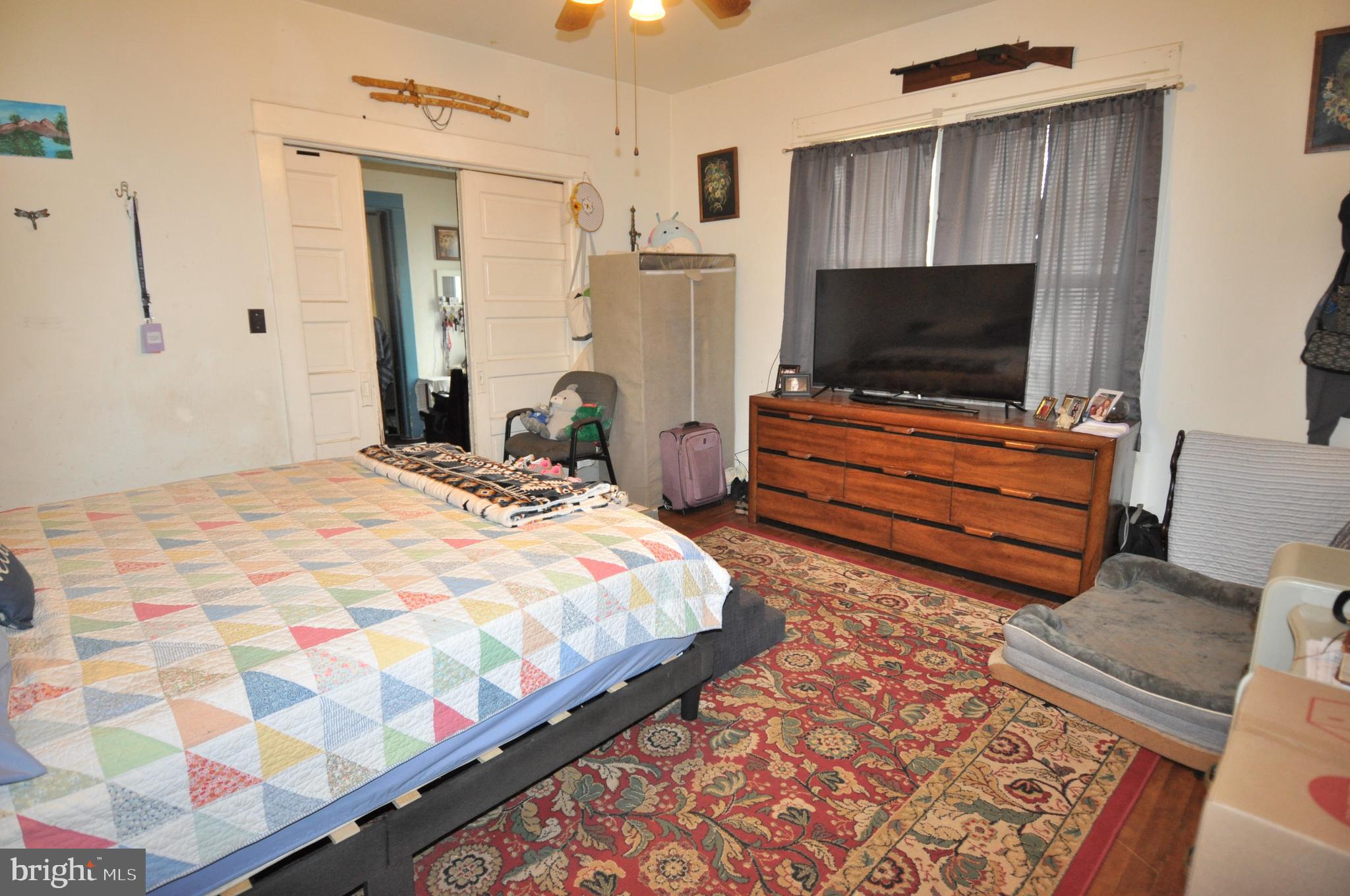105 Front Street Pocomoke City, MD 21851 - Photo 22 of 50 a bedroom with a bed and flat screen tv