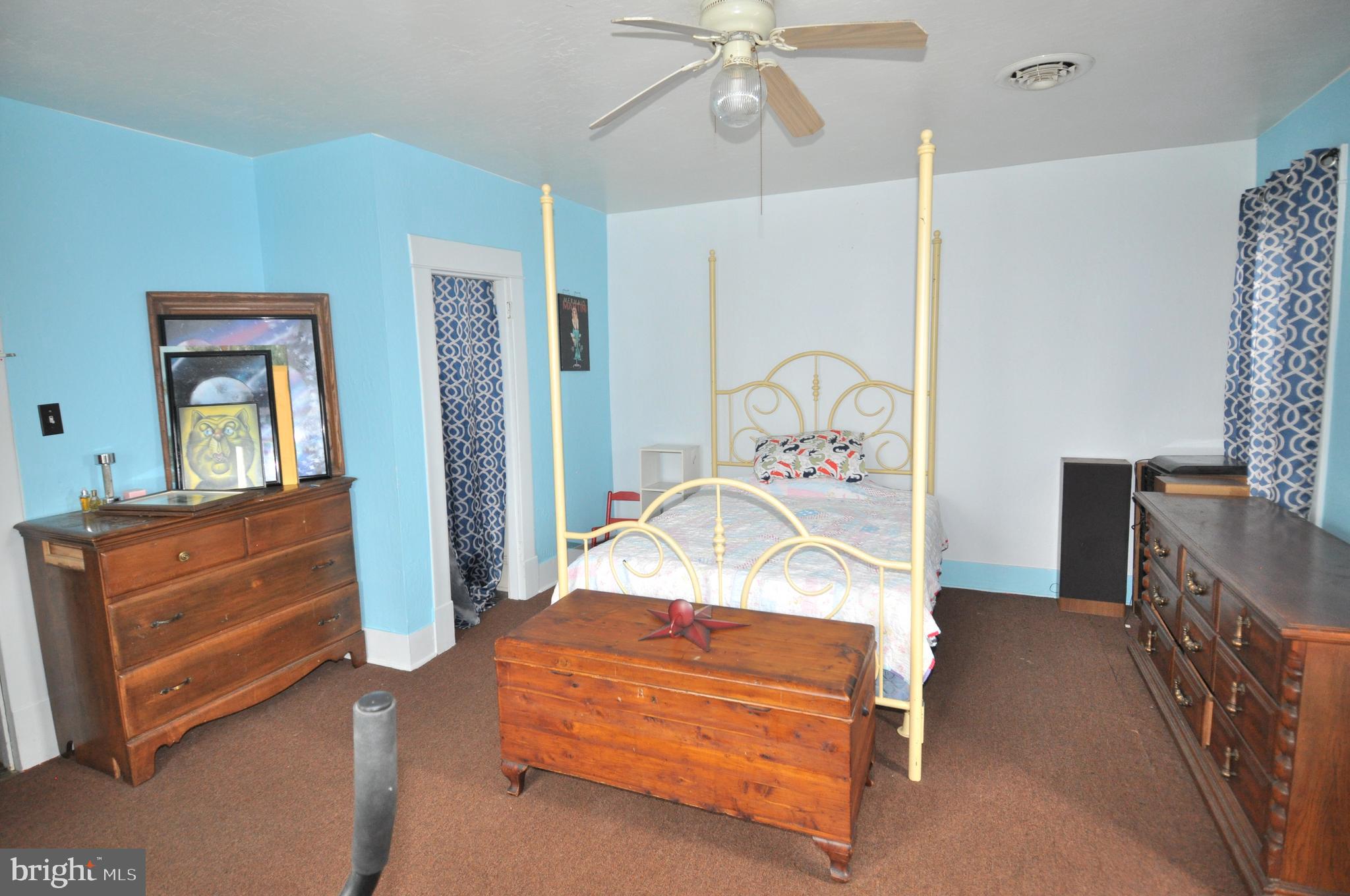 105 Front Street Pocomoke City, MD 21851 - Photo 23 of 50 a bedroom with a bed and a chandelier