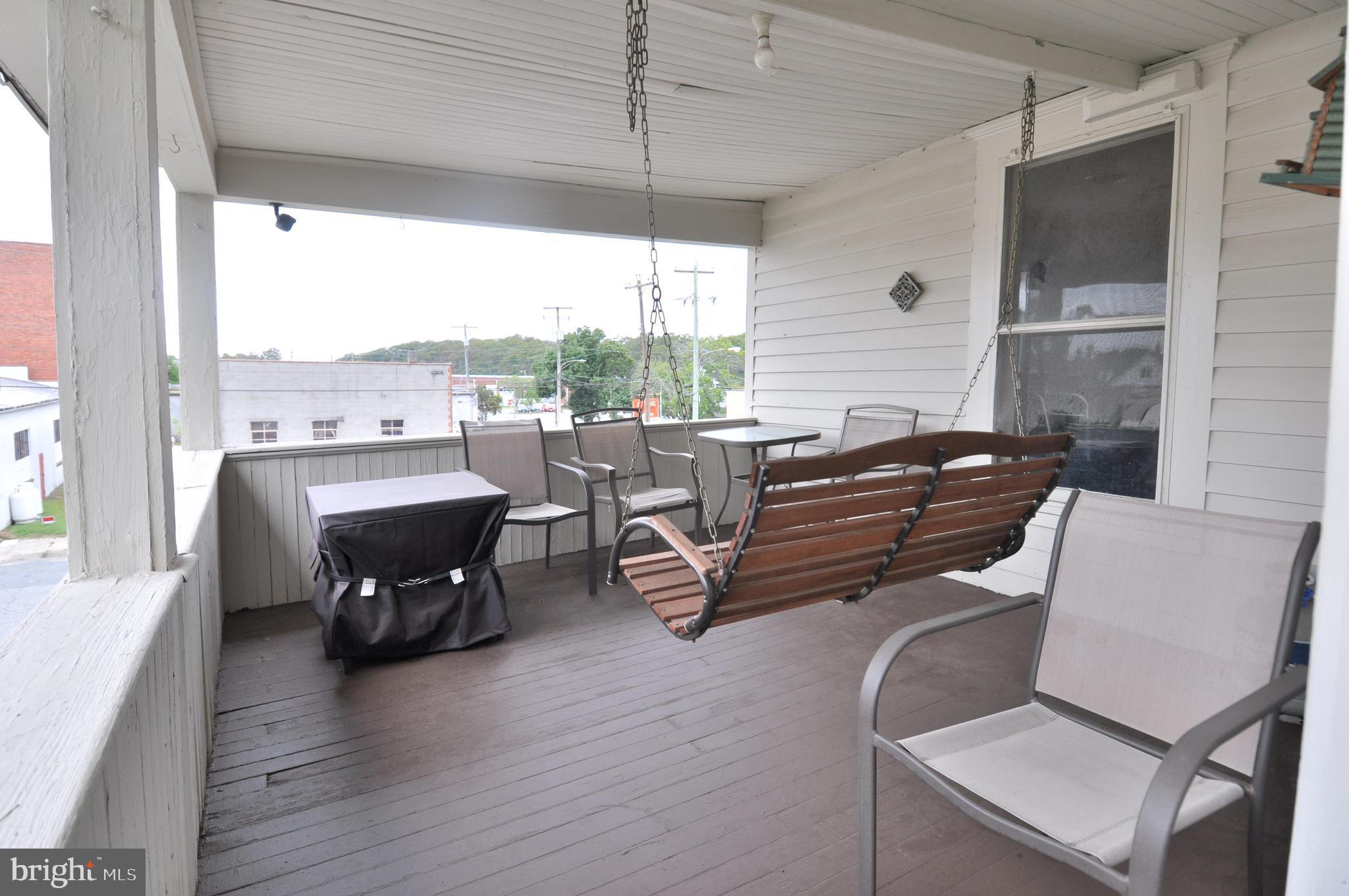 105 Front Street Pocomoke City, MD 21851 - Photo 30 of 50 a living room with furniture a wooden floor and a floor to ceiling window