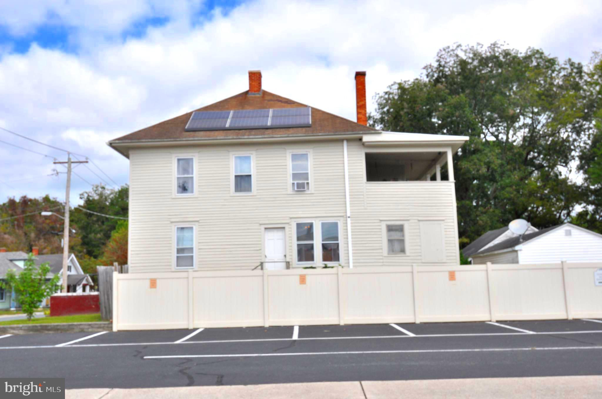 105 Front Street Pocomoke City, MD 21851 - Photo 3 of 50 a front view of a house with a yard