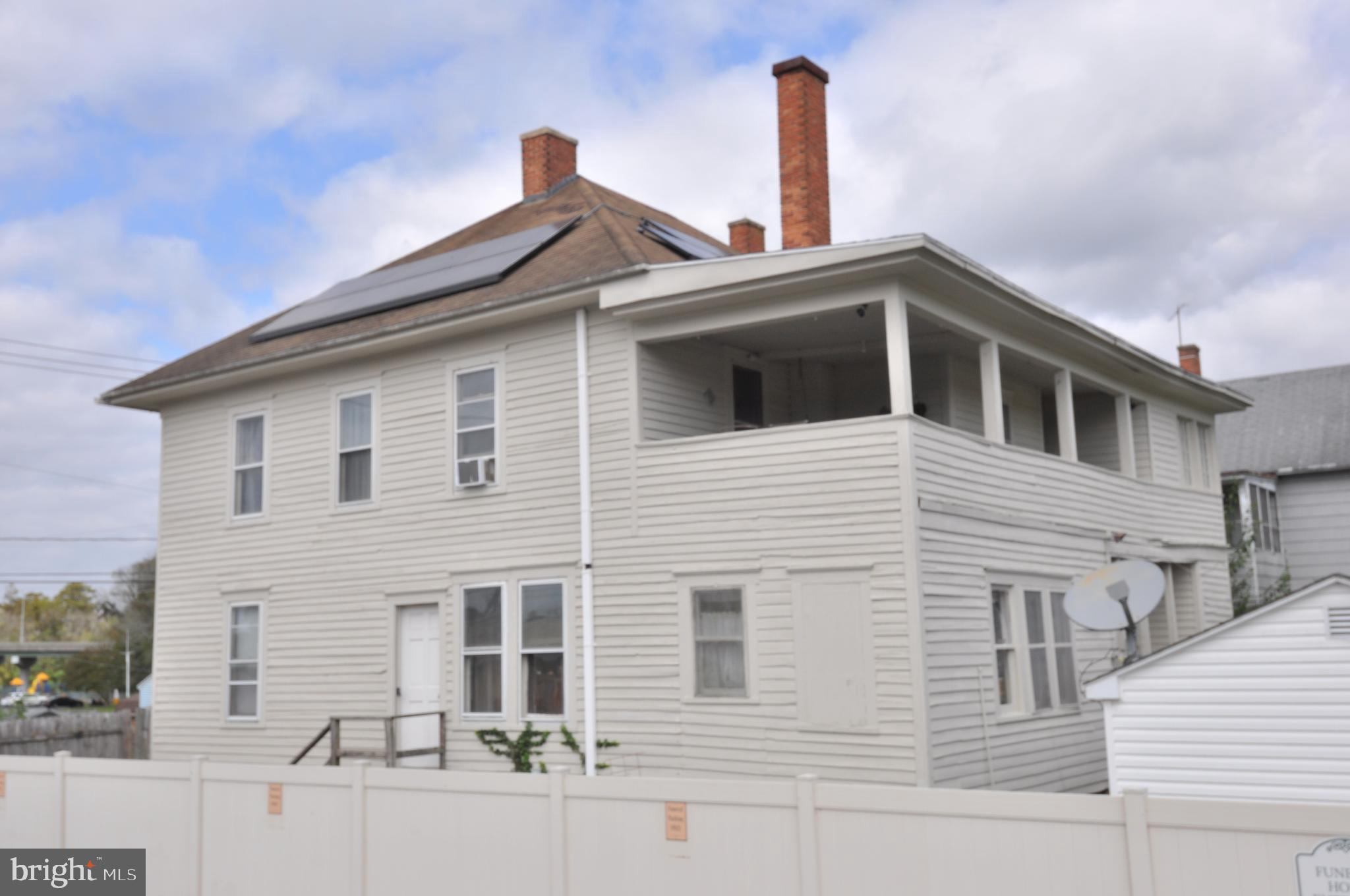 105 Front Street Pocomoke City, MD 21851 - Photo 39 of 50 a front view of a house with a yard