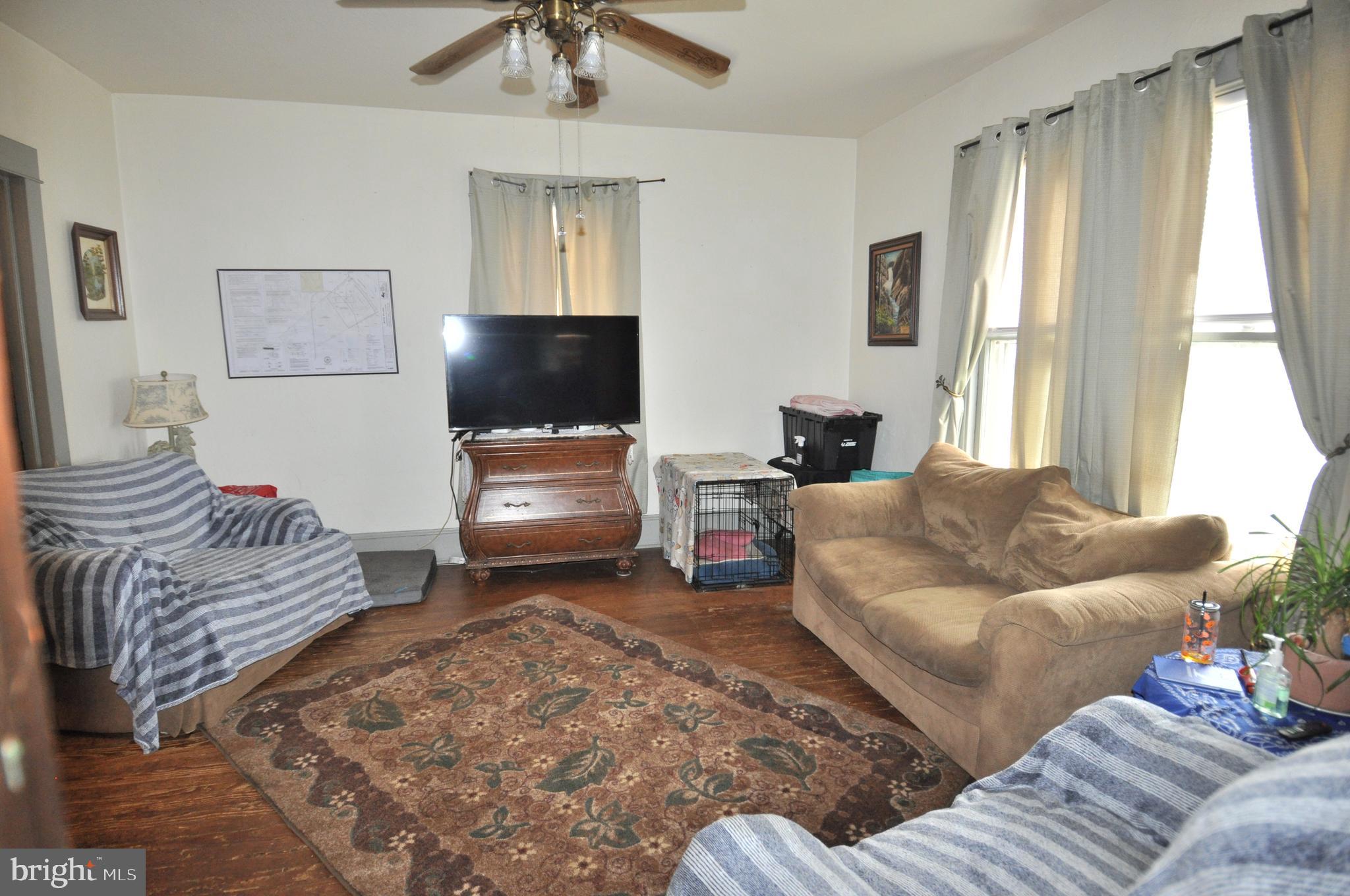 105 Front Street Pocomoke City, MD 21851 - Photo 4 of 50 a living room with furniture and a flat screen tv