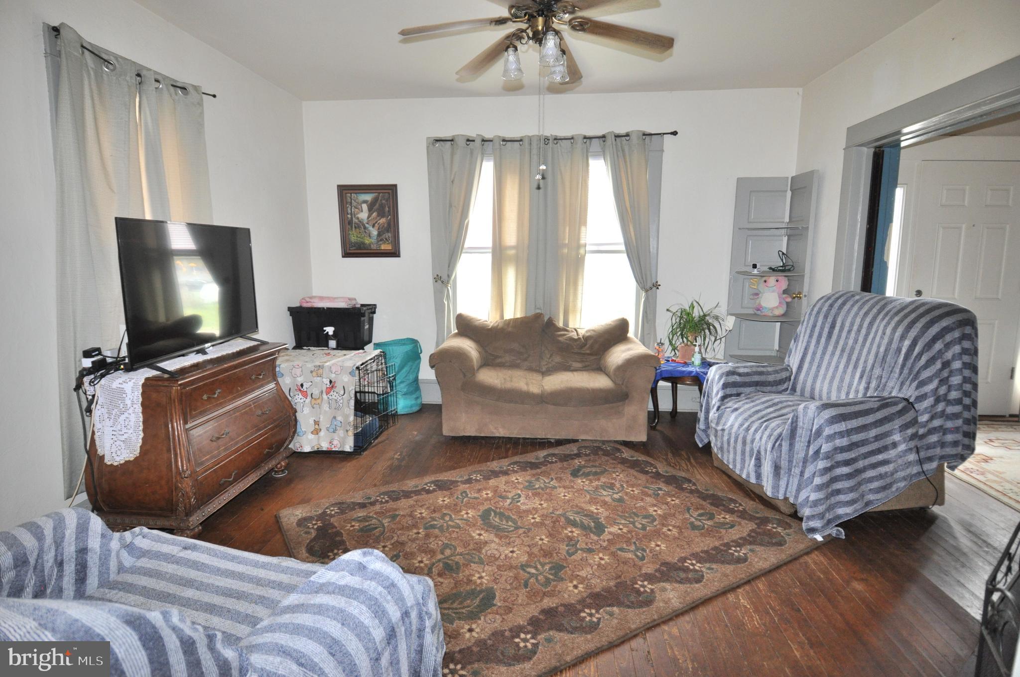 105 Front Street Pocomoke City, MD 21851 - Photo 5 of 50 a living room with furniture and a flat screen tv
