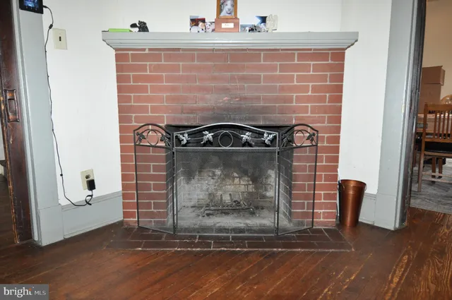 a view of water heater room with wooden floor