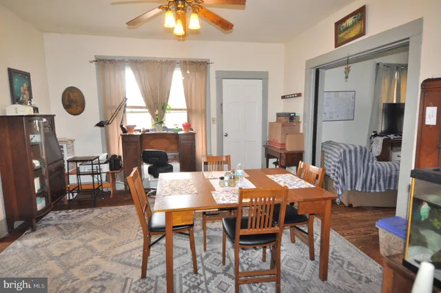 a dining room with furniture a rug and wooden floor
